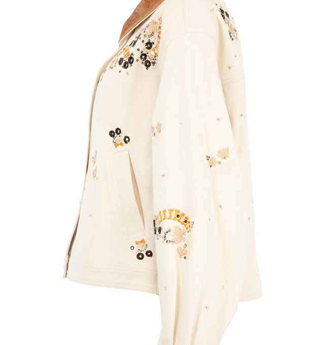 Image 3 of 3 - NEUTRAL - Isabel Marant Women's Lavine Barn Jacket is crafted from ecru cotton denim and features allover floral embroidery and sequin embellishments. The relaxed silhouette is finished with a contrasting crinkled-leather spread collar, front button closure, and welt pockets. Main Material: 100% Cotton. Trim: Leather. 