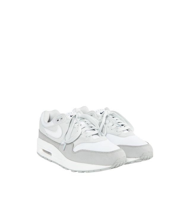 WHITE - Nike's Air Max 1 '87 sneakers crafted from white and grey calf leather and fabric combination with signature Swoosh logo on the sides, round toe, front lace-up fastening, logo-print tongue, branded heel counter, branded insole and signature Air Max 100% rubber sole. 
