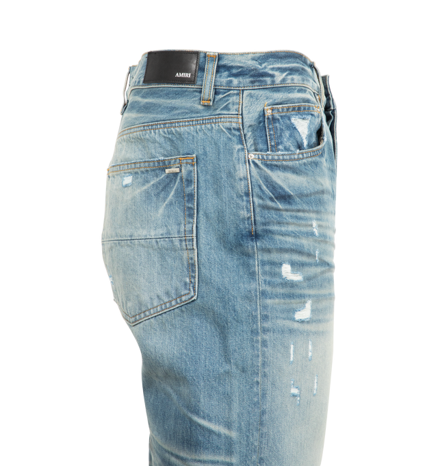 Image 3 of 3 - BLUE - AMIRI Pleated Denim Straight MX1 Jeans featuring fading, whiskering, and hand-distressing throughout, belt loops, five-pocket styling, button-fly, underlay at rips, leather logo patch at back waistband and logo-engraved silver-tone hardware. 92% cotton, 6% elastomultiester, 2% elastane. Made in United States. 