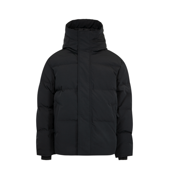 Image 2 of 4 - BLACK - Canada Goose Men's Seymour Parka is crafted from Recycled Organic Arctic Tech and features a quilt-through construction designed for protection in extreme cold-weather conditions. The parka is equipped with an adjustable snorkel hood, a tricot-lined chin guard, and a concealed snap placket over a front zip closure for enhanced coverage. Functional details include interior backpack straps for hands-free carrying, recessed rib-knit cuffs reinforced with CORDURA, two exterior zip pockets 