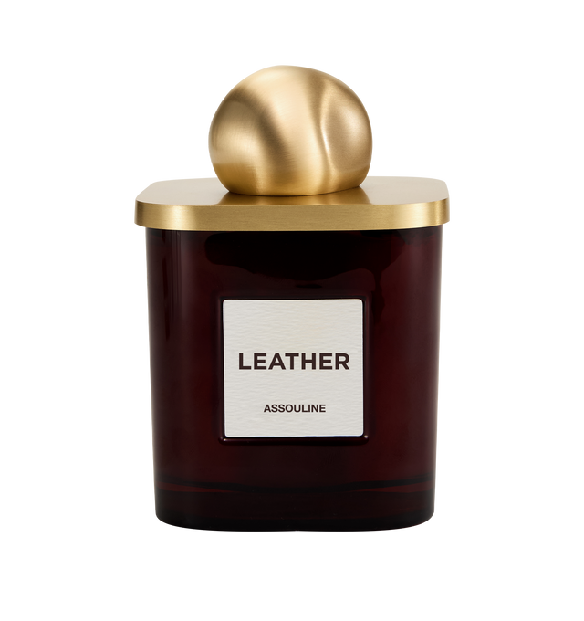 Image 3 of 3 - RED - Assouline Library Candle  Leather is a luxury scented candle that captures the warm, sophisticated ambiance of leather-bound books and refined interiors with a rich fragrance blending leather, clove, tobacco, freesia, orris, and vetiver. Housed in a heavyweight amber glass vessel with a textured paper label, this designer candle is crafted from a premium soy, coconut, and paraffin wax blend for a clean, even burn and exceptional scent throw. Top Notes: Leather, Clove. Heart Notes: Tobac 