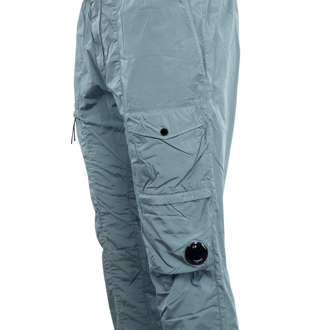 Image 4 of 4 - BLUE - C.P. COMPANY Chrome-R Cargo Lens Pants featuring adjustable drawstring waistband, button and zip fastening, side pockets, cargo flap snap and zip pockets, lens detail, back open pocket with applied logo label, adjustable drawstring hems, garment dyed and regular fit. 100% polyamide/nylon. 