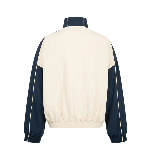 Image 2 of 3 - MULTI - Willy Chavarria Bad Boy Track Jacket is crafted from nylon and features a sleek, true-to-size silhouette defined by bold chevron paneling and contrast piping. Designed with a stand collar, front zip closure, two zippered pockets, stacked script logo detailing, and elasticized cuffs and hem. Main Material: 100% Nylon. Lining: Polyester. 