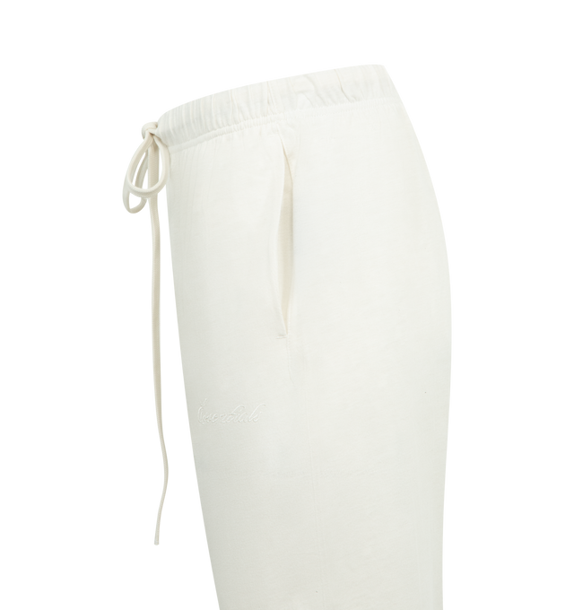 Image 3 of 3 - WHITE - FEAR OF GOD ESSENTIALS Jersey Flare Sweatpant featuring lightweight core jersey, relaxed silhouette that extends into a flared leg, embroidered script Essentials logo on the leg and a Fear of God Essentials label at the center front. 60% cotton, 40% polyester. 