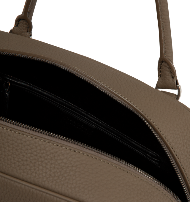 Image 3 of 3 - BROWN - The Row India 12.00 bowling bag in matte grained calfskin leather with tubular handles, branded metal padlock and key, 1 interior zipped pocket, 1 slot pocket and zipper closure. Measures 12 x 9.5 x 12 in. with 4.75 in. handle drop. 100% calfskin leather lined in 100% lambskin leather. Made in Italy. 