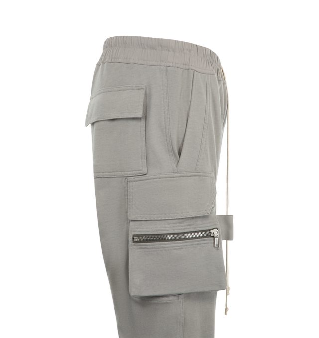 Image 3 of 3 - GREY - Rick Owens Mens Mastodon Cargo Pants are crafted from cotton poplin. Feature a slim fit, elasticized waistband with drawstring, side pockets, zip cargo pannier pockets with flaps and tabs, back flap pockets, and elasticized ankles. Main Material: 97% Cotton, 3% Elastane. Made in Italy. 