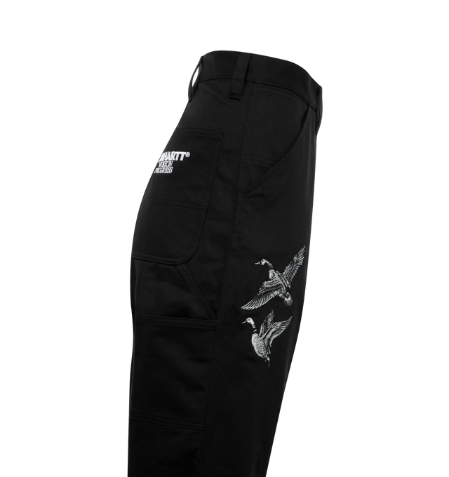 Image 3 of 3 - BLACK - CARHARTT WIP Ducks Single Knee Pant featuring midweight cotton twill in a relaxed straight fit, with a silhouette inspired by the classic work pant. The item is detailed with allover graphic embroidery, triple-stitched detail, tool pockets and a hammer loop. 100% cotton. 