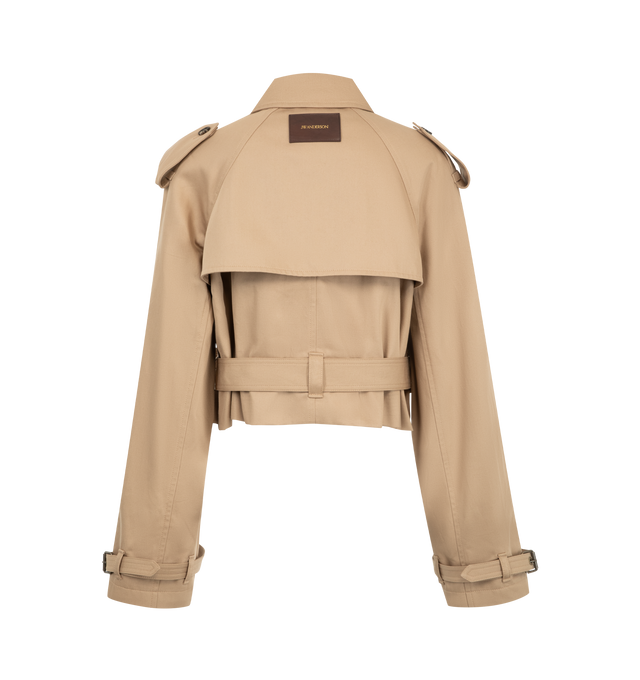 Image 2 of 3 - NEUTRAL - JW Anderson Women's Cropped Trench Coat is crafted from water-resistant cotton and features a cropped, boxy-fit silhouette that reinterprets the classic trench coat with a contemporary proportion. Designed with traditional trench details including a gun flap, throat latch, storm shield, self-fabric belt at the waist and cuffs, welt pockets, horn buttons, and a full cotton lining. Main Material: 100% Cotton. Lining: 100% Cotton. Made in Italy. 