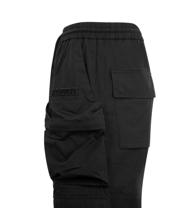 Image 3 of 3 - BLACK - AMIRI Multi Pocket Cargo Pant featuring elastic waistband with drawcord, snap buttons at ankle, cargo pockets and relaxed fit. 72% cotton, 28% nylon. Made in Italy. 