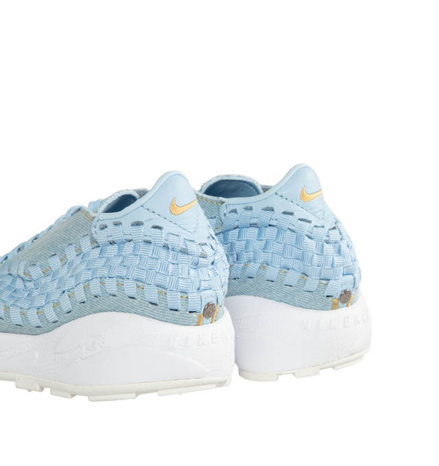 Image 3 of 5 - BLUE - NIKE Air Footscape Woven Sneakers featuring a pale blue colored textile and soft suede upper, asymmetrical woven details, lateral lacing, foam midsole, Nike Air cushioned heel and rubber outsole. 