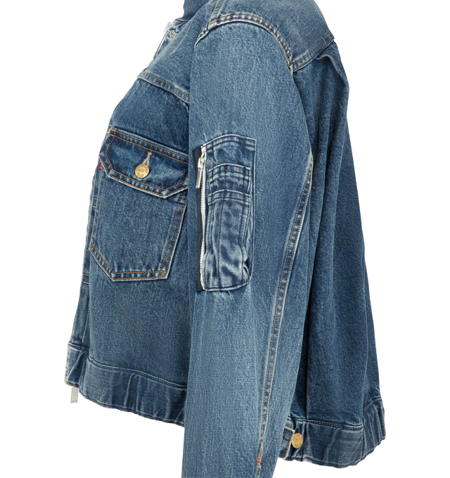 Image 3 of 4 - BLUE - Sacai X Levi's Women's Denim Jacket are crafted from a medium wash cotton denim featuring a deconstructed denim design with a central zipper and utility pocket details on the sleeve. Main Material: 100% Cotton. Made in Japan. 