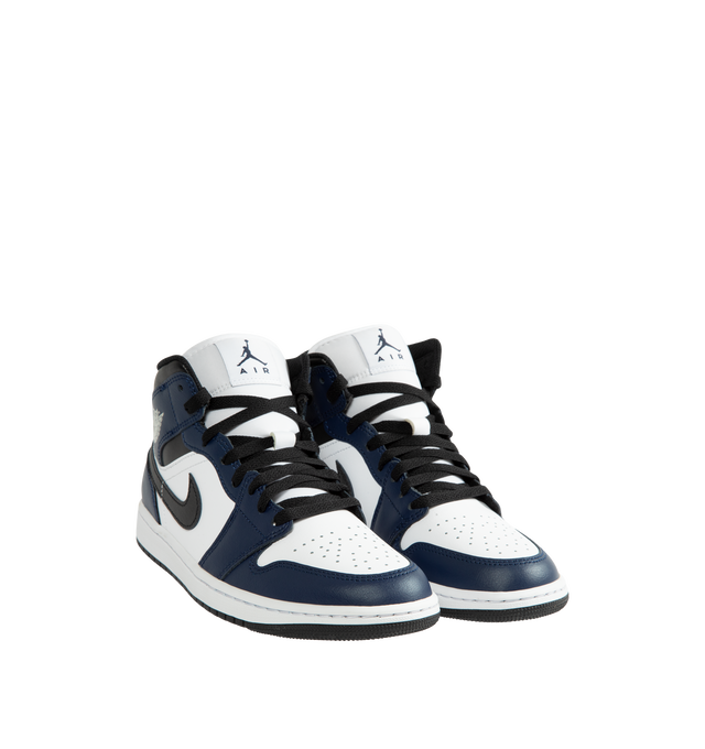 Image 2 of 5 - NAVY - Air Jordan 1 Mid Men's Shoes are crafted with a combination of leather, synthetic leather, and textile materials and feature the iconic mid-top silhouette inspired by the original Air Jordan 1. Designed with Nike Air cushioning, a foam midsole, and a durable rubber outsole with a pivot circle, this classic sneaker delivers lightweight comfort and everyday traction. Signature details include a stitched Swoosh logo, Wings logo at the collar, and Jumpman branding at the tongue. Main Mater 
