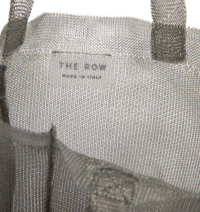 Image 3 of 3 - SILVER - THE ROW Imogen Mini Tote Bag in Steel featuring semi-transparent steel with two flat top handles and single interior compartment. Unlined. 6 x 2 x 7.5 in. Handle: 3.5 in. drop. 87% steel, 13% polyester. Made in Italy. 