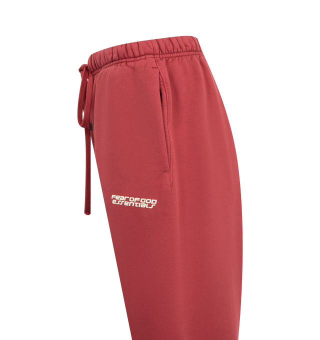 Image 3 of 3 - RED - FEAR OF GOD ESSENTIALS Classic Sweatpant featuring front drawstring tie closure, elasticized waistband, side seam pockets and front printed logo and heavyweight knit fabric with fleece lining. 100% cotton. 