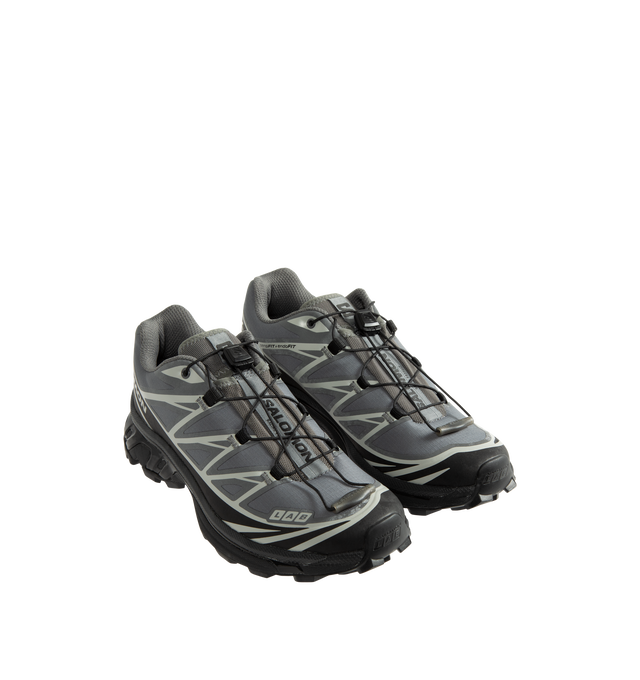 Image 2 of 5 - GREY - Salomon XT-6 Protective Sneakers are crafted from ripstop textile with textured TPU film overlays and feature the brand's iconic XT-6 silhouette reimagined through a durable workwear-inspired lens. Designed with Salomon's signature SensiFit construction, soft cushioning, and downhill stability technology, this technical style balances rugged functionality with everyday versatility. Main Material: Synthetic and Textile Upper. Lining: Textile. Insole: Textile. Outsole: Rubber. Closure: Q 