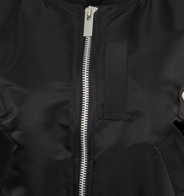 Image 3 of 3 - BLACK - SACAI Nylon Twill Blouson featuring round collar, two-way zip closure, front pockets, webbing straps and button tabs details, zipped pocket on the left sleeve, exaggerated rucked sleeves and ribbed edges. 100% nylon. 