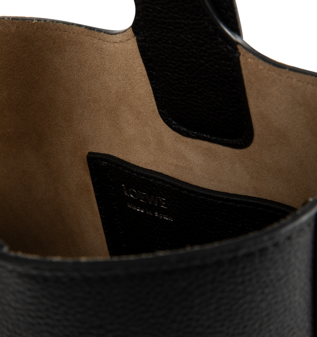 Image 3 of 3 - BLACK - Loewe Pebble is a minimalistic bucket bag with a wide strap adjustable through an oversized Pebble closure. This mini version is crafted in soft grained calfskin.Crossbody, shoulder or hand carry with additional adjustable and removable strap. Features one internal pocket, suede lining, Anagram Pebble. Made in Spain. 