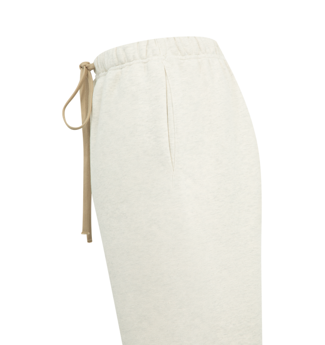 Image 3 of 3 - WHITE - FEAR OF GOD ESSENTIALS Classic Sweatpant featuring 480gsm core fleece, relaxed silhouette that tapers into an elastic hem, encased elastic waistband with elongated drawcords, side seam pockets and a Fear of God Essentials label stitched at the center front. 80% cotton, 20% polyester. 