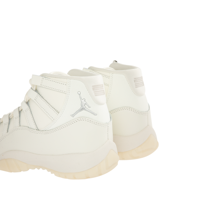 Image 3 of 5 - WHITE - JORDAN Air Jordan 11 Retro Sneaker featuring patent leather upper, lace-up front, foam midsole, Air cushioning, rounded toe, pearl charm and rubber outsole. 