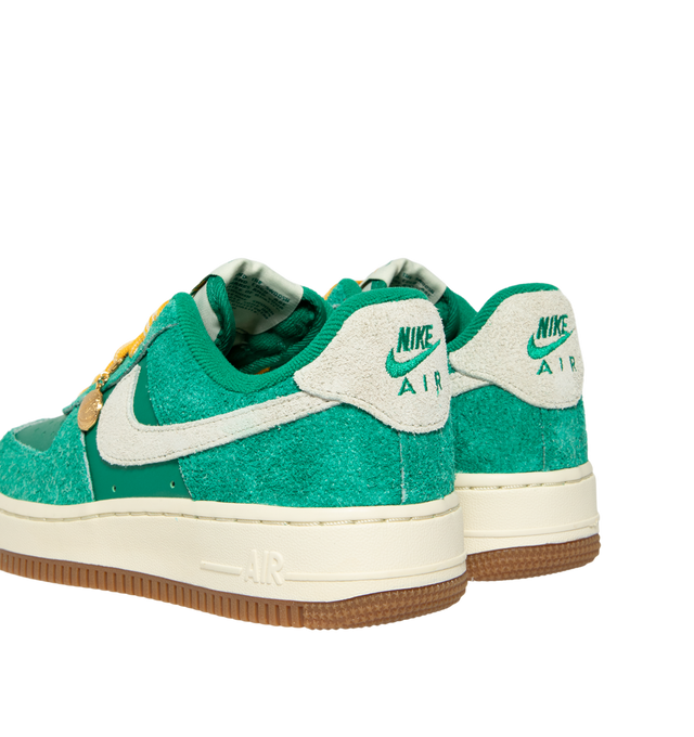 Image 3 of 5 - GREEN - Nike Women's Air Force 1 07' Game Day Sneakers feature a genuine and synthetic leather upper with a perforated toe box for breathable comfort and a timeless look. These iconic lifestyle sneakers combine lightweight Nike Air cushioning, a padded collar, and a durable rubber outsole with classic pivot-circle traction for everyday wear. Clip-on charms add a customizable finishing touch. Main Material: Genuine Leather and Synthetic Leather. Midsole: Foam with Nike Air Unit. Sole: Rubber.  