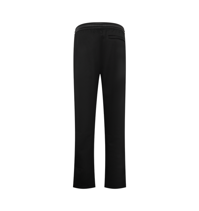 Image 2 of 3 - BLACK - Wales Bonner Men's Form Track Pant is crafted from a stretch cotton-blend piqu fabric and features a straight-leg silhouette with side stripe detailing and piped trim. Designed with an elasticized waistband and concealed drawstring, these track pants are finished with pinched seams at the legs, zip vents at the cuffs, two side welt pockets, and a rear welt pocket with logo embroidery. Main Material: 56% Polyester, 39% Cotton, 5% Elastane. Lining: 100% Organic Cotton. Trim: 100% Viscos 