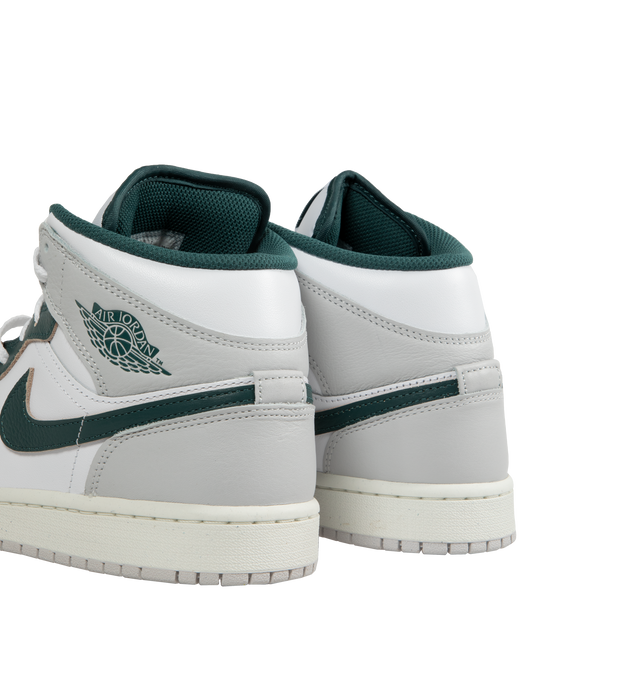 Image 4 of 5 - MULTI - AIR JORDAN 1 MID SE basketball shoe in White, Oxidized Green, Sail, and Neutral Grey leather upper featuring an angled profile, toe box perforations, mesh tongues and lining, encapsulated Air cushioning underfoot, and distinctive Jordan detailing. Air-Sole cushioning provides lightweight, responsive comfort.  Leather and textile upper/synthetic lining/rubber sole. 