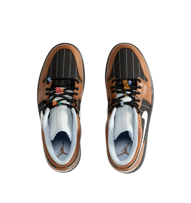 Image 5 of 5 - BROWN - Men's Air Jordan 1 Low SE Sneakers feature a genuine leather and suede upper with the iconic low-top silhouette, signature Wings branding, and a Jumpman logo for a premium take on a timeless classic. These lifestyle sneakers combine encapsulated Air-Sole cushioning with a durable rubber outsole for lightweight comfort, lasting support, and reliable everyday traction. Main Material: Genuine Leather and Suede. Midsole: Encapsulated Air-Sole Unit. Sole: Rubber. 