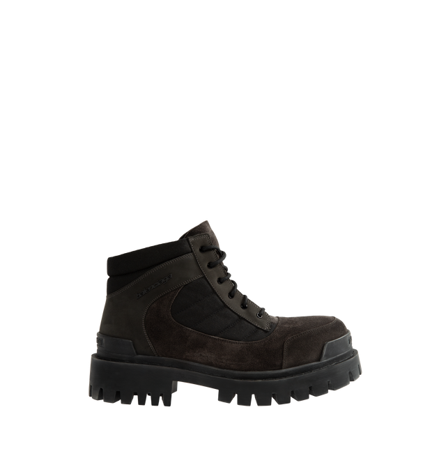 Image 1 of 4 - BROWN - Balenciaga Men's Combat Strike Low Boot is crafted from nubuck calfskin, suede calfskin, and cotton canvas and features an extra-round toe, a six-eyelet lace-up vamp, visible topstitching, and a worn-effect finish. Designed with a thick toothed rubber outsole, this low-profile combat boot is finished with Balenciaga logo detailing at the exterior, front, and back. Main Material: Calfskin leathers and Sole: TPU, Polyurethane. Heel Height: 20 mm / 0.8 in. Made in Italy. 