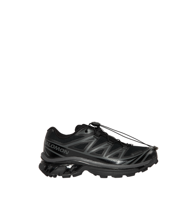 Image 1 of 5 - BLACK - Salomon Men's XT-6 GORE-TEX Sneakers are crafted with a lightweight textile upper and feature waterproof GORE-TEX protection, the brand's Agile Chassis System, and Quicklace technology for a secure, precise fit. Originally developed for ultra-distance trail running, these designer sneakers combine superior cushioning, stability, and all-terrain grip with Salomon's signature technical aesthetic, making them ideal for both outdoor performance and everyday wear. Main Material: Textile an 