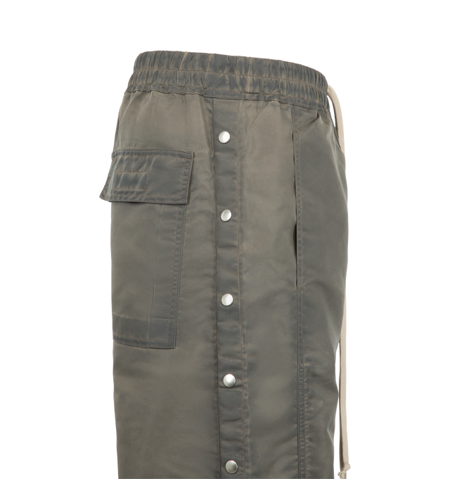 Image 3 of 3 - GREY - Rick Owens DRKSHDW Men's Wide Pusher Pants are crafted from washed bomber satin and feature a floor-length wide-leg silhouette with a slightly dropped crotch, an elasticized drawstring waistband, side pockets, flap back pockets, and snap closures along the outer legs that can be worn open or closed. Main Material: 100% Nylon.  