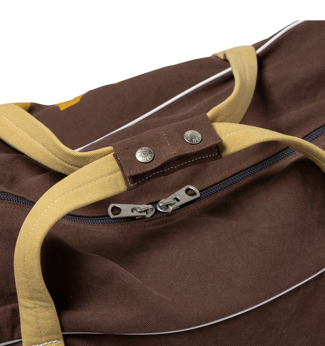 Image 4 of 8 - BROWN - HUMAN MADE Canvas Boston Bag Large featuring thick, tough cotton canvas, bio-washed for a vintage-like feel, graphics appear on both sides, external pocket and an internal zip pocket, heart-shaped rivets and 100L capacity. 100% cotton.  