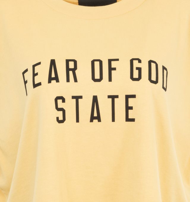 Image 3 of 3 - YELLOW - Fear of God Cropped Muscle T-Shirt has a crew neck, printed logo, cropped hem, and logo patch at the back collar. Cotton-blend jersey.  