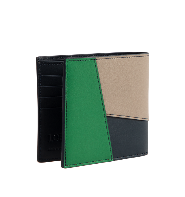 Image 2 of 3 - MULTI - Loewe Puzzle bifold wallet in classic calfskin, inspired by the Puzzle bag's distinctive geometric pattern. This version is crafted in classic calfskin in contrasting Sand, Black and Tropical Green colours. Featuring eight card slots, two large note pockets, two flat pockets, calfskin lining and embossed Anagram. Made in Spain. Height 3.9in X Width 4.3in X Depth 0.7in. 