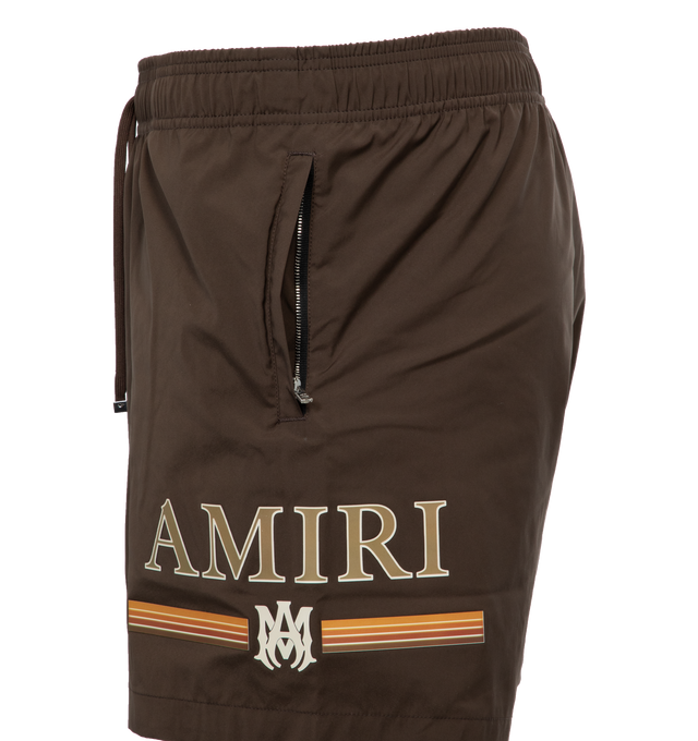 Image 3 of 4 - BROWN - AMIRI Swimshort featuring a gradient bar logo at the left thigh, crafted with side seam pockets, back flap pocket, elastic waist and drawcord. Made in Italy.  90% POLYESTER 10% SPANDEX. 