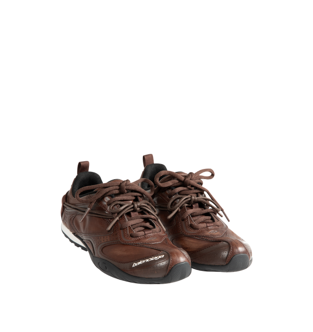 Image 2 of 5 - BROWN - Balenciaga Women's Radar Leather Sneakers are crafted from premium cowskin leather and feature a streamlined low-top silhouette with a distinctive worn-in finish, double lacing system, and debossed Balenciaga and 3B Sport logo detailing. Inspired by speed and technical performance, these designer sneakers are finished with a padded foam insole, durable rubber outsole with signature loop sports icon artwork, a back pull tab, and a sleek profile for elevated everyday wear. Upper: Cowski 