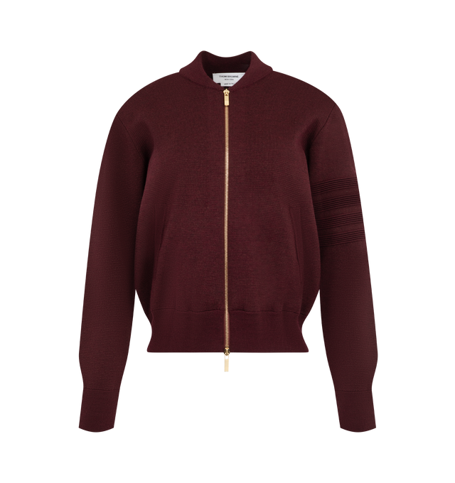 Image 1 of 3 - RED - Thom Browne Women's Ottoman Milano Stitch 4-Bar Bomber Jacket is crafted from wool and features the brands signature 4-bar detailing rendered in a raised ottoman-stitch construction along the sleeve. Designed with a refined bomber silhouette, the jacket is finished with a two-way zip closure, rib-knit bomber collar, cuffs, and hem, and welt hand pockets with rib-knit trim. Thom Brownes signature striped grosgrain loop tab completes the design. Main Material: Wool. Made in Italy. 