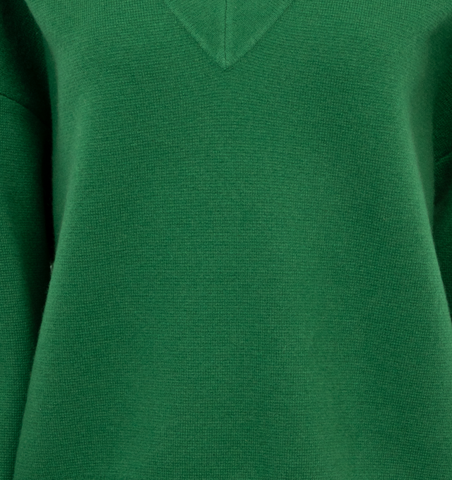 GREEN - EXTREME CASHMERE Lana Sweater featuring voluminous sleeves, ribbed V-neck, drop shoulder, long sleeves, ribbed cuffs and hem and signature embroidered-detail to the cuff. 100% cashmere.