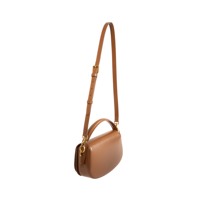 Image 2 of 3 - BROWN - SAINT LAURENT Voltaire Box Bag featuring half-moon shoulder bag in calfskin with a gently polished finish, flap with pivoting cassandre closure, an adjustable and detachable swivel-hook strap, leather lining, bronze-toned hardware and one flat pocket. 9.4" x 5.9" x 2". Handle drop: 2.4". Strap drop: 10.6". Calfskin leather. Made in Italy. 