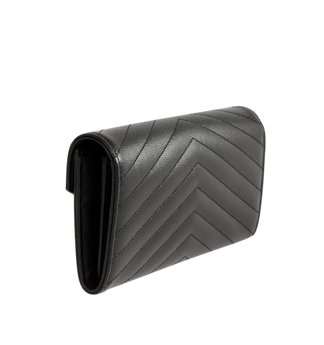 Image 2 of 3 - BLACK - SAINT LAURENT Large Wallet featuring large flap wallet made with metal-free tanned leather, cassandre on front, gold-toned metal hardware, snap button fastening, twelve card slots, one coin pocket, two bill compartments, two receipt compartments and quilted overstitching. 7.4 x 4.3 x 1.1 inches. Calfskin. Made in Italy. 