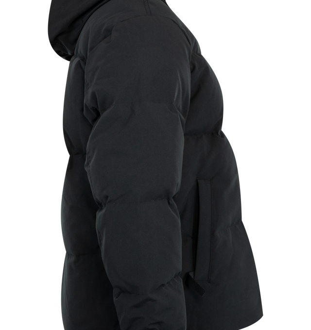 Image 4 of 4 - BLACK - Canada Goose Men's Seymour Parka is crafted from Recycled Organic Arctic Tech and features a quilt-through construction designed for protection in extreme cold-weather conditions. The parka is equipped with an adjustable snorkel hood, a tricot-lined chin guard, and a concealed snap placket over a front zip closure for enhanced coverage. Functional details include interior backpack straps for hands-free carrying, recessed rib-knit cuffs reinforced with CORDURA, two exterior zip pockets 
