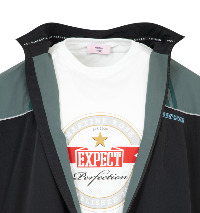 Image 4 of 4 - BLACK - MARTINE ROSE Paneled Nylon Track Jacket with Graphic T-Shirt Lining featuring nylon track jacket prelayered with a peekaboo cotton T-shirt, front zip closure, stand collar, front welt pockets and lined. 100% nylon, with 100% cotton contrast. 