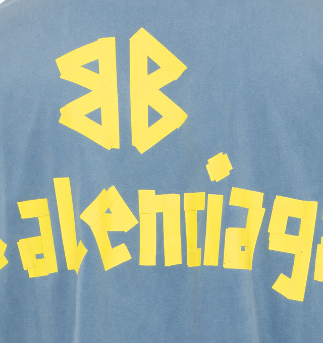 BLUE - BALENCIAGA Tape Type T-Shirt Medium Fit featuring vintage jersey, crewneck, short sleeves, tape Type logo at front and back and worn-out and washed-out effect. 100% cotton. Made in Portugal.