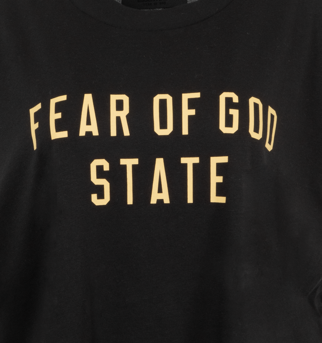 Image 3 of 6 - BLACK - Fear of God Cropped Muscle T-Shirt has a crew neck, printed logo, cropped hem, and logo patch at the back collar. Cotton-blend jersey.  