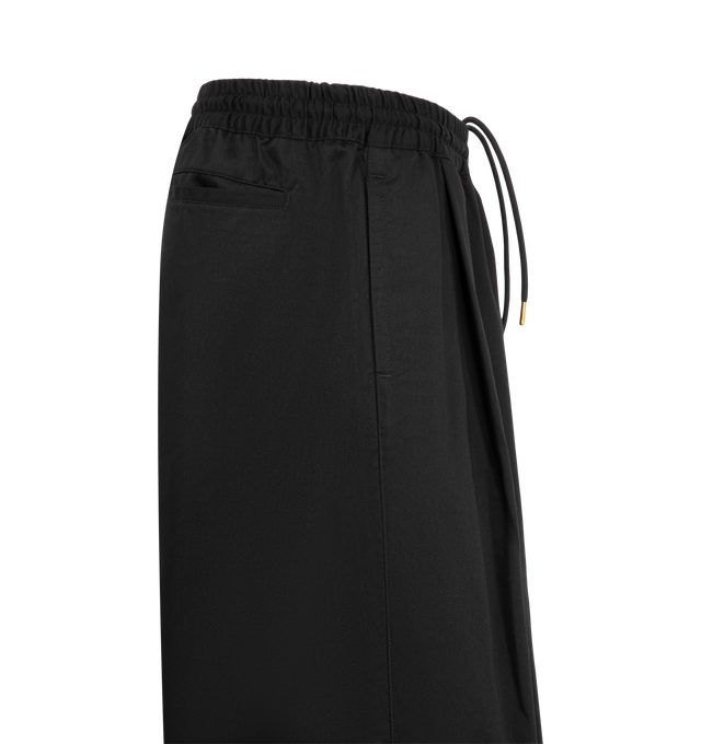 Image 3 of 3 - BLACK - Willy Chavarria Orale Elasticated Short is crafted from a polyester-cotton blend and features a relaxed, voluminous silhouette with an elasticated waistband for everyday comfort. Designed with the brand's signature oversized proportions and clean utility-inspired styling. Main Material: 65% Polyester, 35% Cotton. Lining: 100% Cotton. Made in USA. 