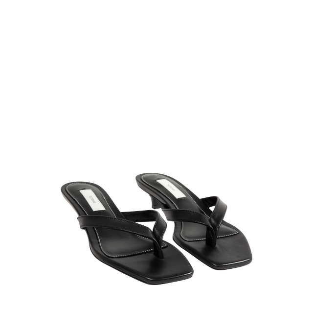 Image 2 of 4 - BLACK - Toteme Women's Leather Heeled Flip Flops are crafted in Italy from smooth, responsibly tanned leather and feature a minimalist thong silhouette with an open toe and easy slip-on construction. Set on a low 35mm heel, these designer sandals are finished with a leather lining and leather outsole, combining understated elegance with Toteme's signature minimalist aesthetic. Upper: Responsibly Tanned Leather. Lining: Leather. Outsole: Leather. Heel Height: 35 mm / 1.4 in. Made in Italy. 