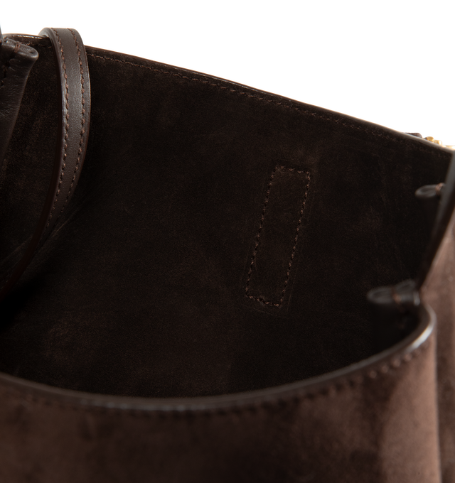 Image 5 of 5 - BROWN - Saint Laurent Women's Le 5  7 Supple Crossbody Bag is crafted from calfskin suede with a tonal suede lining. The spacious silhouette features bronze-tone hardware, a Cassandre hook closure, a removable zip pouch, and an adjustable strap for crossbody carry. Fits a large phone, wallet, sunglasses, and keys. Main Material: Calfskin Leather. Hardware: Brass. Dimensions: 22.5 x 23 x 8.5 cm / 8.9 x 9.1 x 3.3 in. Strap Drop: 50 cm / 19.7 in. Made in Italy. 