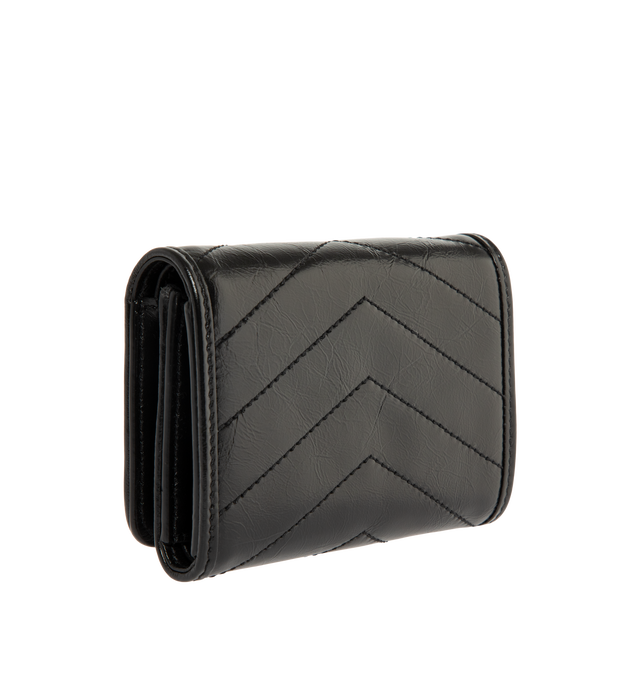 Image 2 of 3 - BLACK - Saint Laurent Womens Tri-Fold Wallet is crafted from calfskin leather. Features signature CASSANDRE hardware, quilted topstitching, snap-button closure, six card slots, one bill compartment, one zip coin pocket, and bronze-tone hardware. Dimensions: 12  11.5  2.5 cm. Main Material: Calfskin Leather; Hardware: Brass. Made in Italy. 