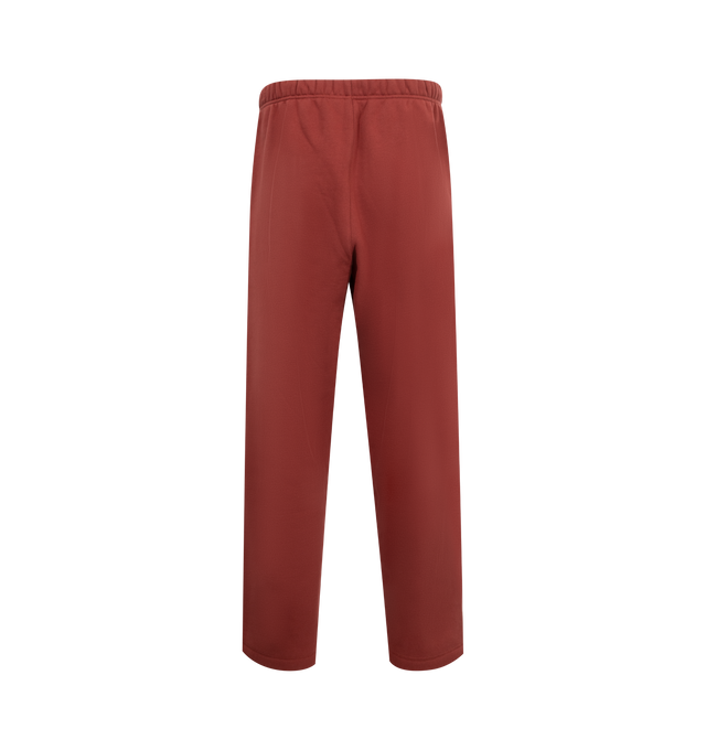 Image 2 of 3 - RED - FEAR OF GOD ESSENTIALS Fleece Relaxed Sweatpant featuring a straight leg, drawstring fastening, elasticated waistband, side seam pockets, and screen print design. 80% Cotton, 20% Polyester. 