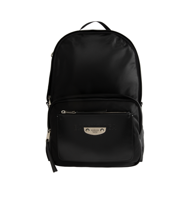 Image 1 of 3 - BLACK - Balenciaga Sleek Mens Nylon Backpack is crafted from black recycled nylon with smooth leather trim and features a zip-around closure and adjustable padded shoulder straps with metal hardware. A circular top handle, front logo print, metal logo plaque, interior pocket, and front compartment with two zippers complete the design. Fits a tablet, notebook, wallet, phone, keys, and small water bottle. Main Material: 100% Recycled Nylon. Leather Detail: Smooth Leather. Dimensions: 30 x 14 x  