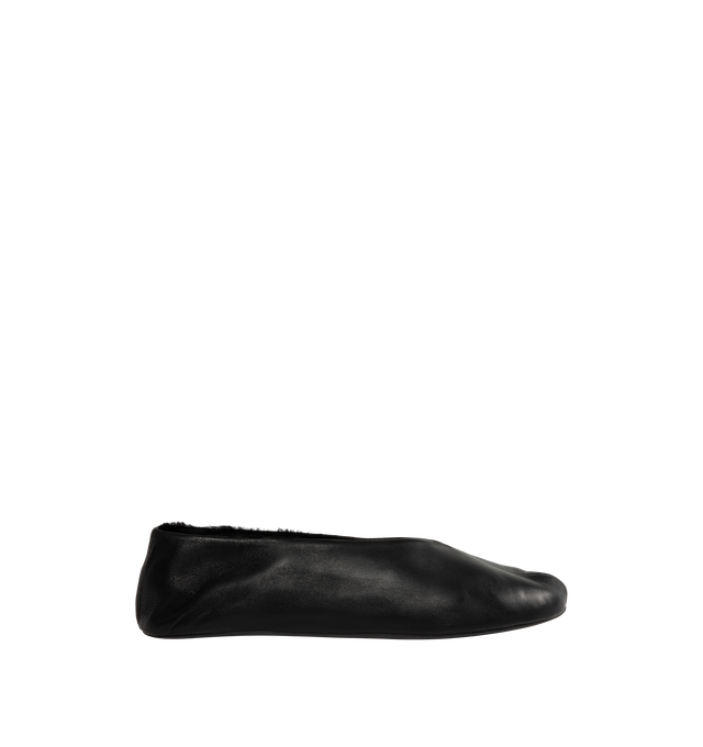 Image 1 of 4 - BLACK - The Row Women's Stella Slippers are crafted from smooth nappa lambskin leather and feature a slip-on silhouette with an oval toe, soft shearling lining, and a flexible rubber-coated sole. These designer leather slippers combine exceptional Italian craftsmanship with luxurious comfort, making them an elevated choice for effortless everyday wear. Main Material: 100% Lambskin Leather. Lining: Shearling. Sole: Rubber-Coated. Made in Italy. 